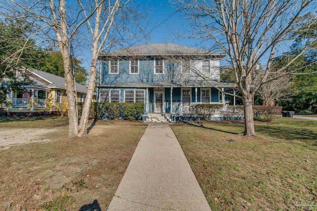 view of front of property featuring covered porch and a front yard