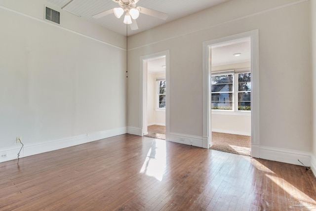 empty room with hardwood / wood-style flooring and ceiling fan