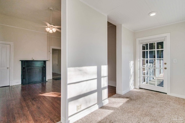 spare room featuring ceiling fan, dark carpet, and ornamental molding