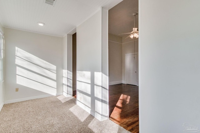 carpeted spare room with ceiling fan and ornamental molding