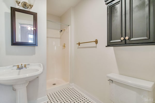 bathroom with a shower and toilet