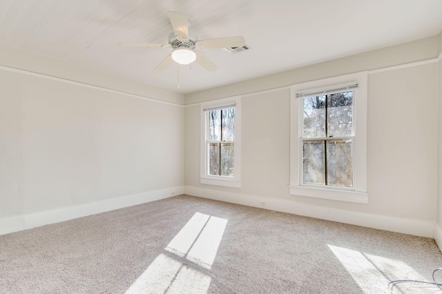 empty room featuring ceiling fan, a healthy amount of sunlight, and carpet floors