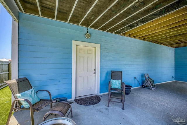 view of exterior entry featuring a patio area