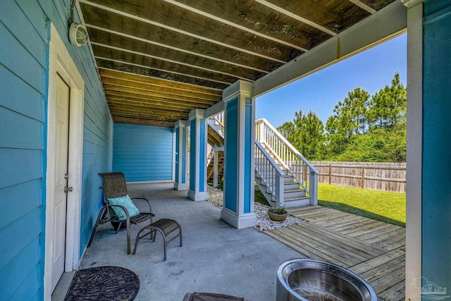 view of patio with fence and stairs
