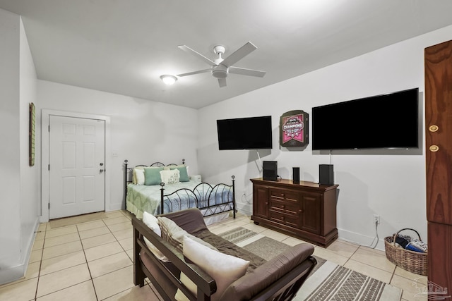 bedroom with ceiling fan, light tile patterned flooring, and baseboards