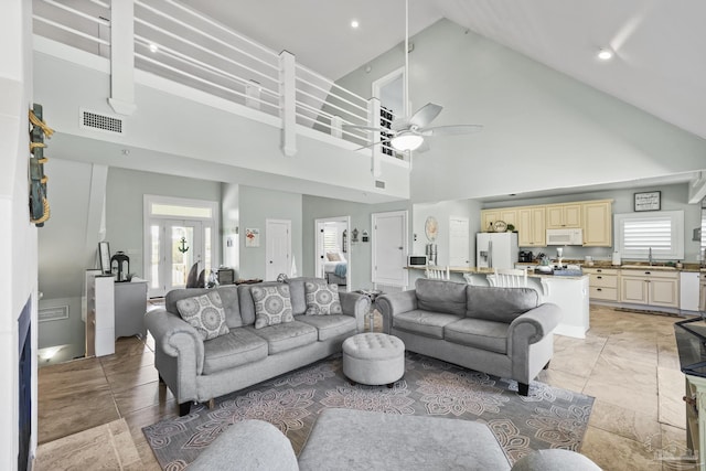 living room with visible vents, ceiling fan, high vaulted ceiling, and recessed lighting