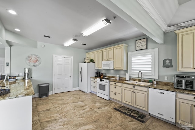 kitchen featuring a sink, white appliances, visible vents, and cream cabinetry