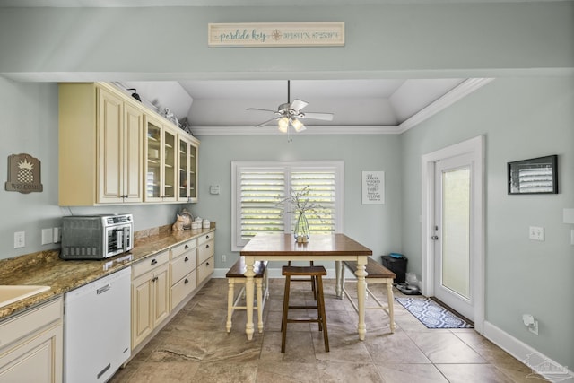 dining area with ornamental molding, baseboards, a ceiling fan, and a toaster
