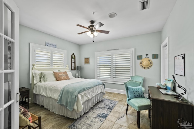 bedroom with visible vents, baseboards, and a ceiling fan