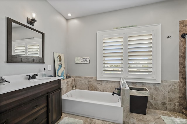 full bath featuring vanity and a garden tub