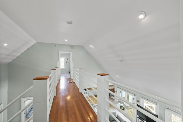 hall with recessed lighting, an upstairs landing, wood finished floors, and vaulted ceiling