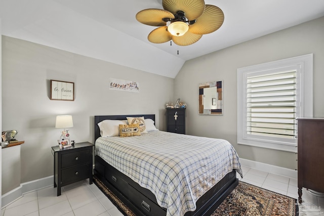 bedroom with light tile patterned floors, baseboards, a ceiling fan, and vaulted ceiling