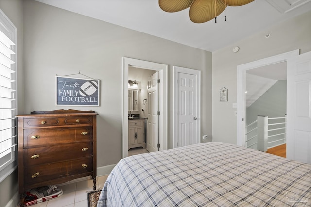 tiled bedroom with connected bathroom and ceiling fan