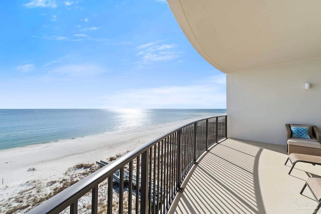 balcony with a water view and a beach view