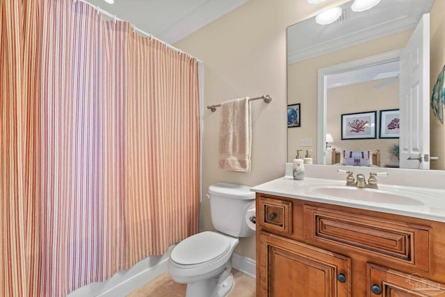 bathroom featuring vanity, toilet, and ornamental molding