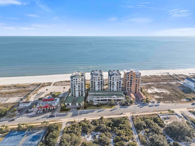 bird's eye view featuring a water view and a beach view