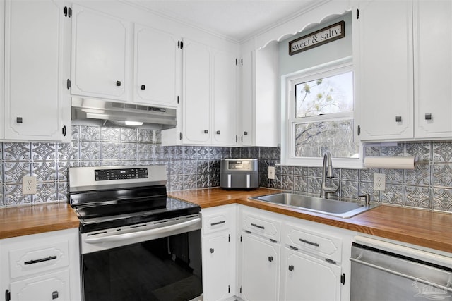 kitchen featuring a sink, appliances with stainless steel finishes, under cabinet range hood, tasteful backsplash, and butcher block counters