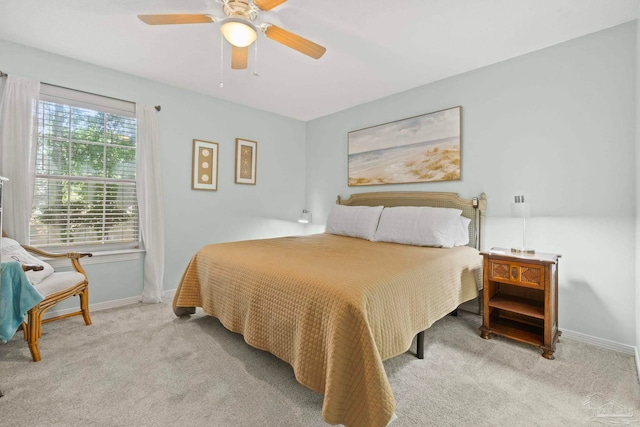 carpeted bedroom featuring a ceiling fan and baseboards