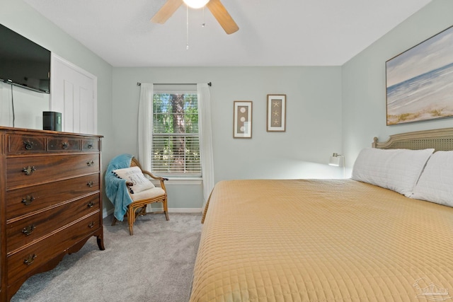 bedroom featuring a ceiling fan, baseboards, and light carpet