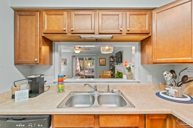 kitchen with ceiling fan, brown cabinetry, dishwasher, a sink, and light countertops