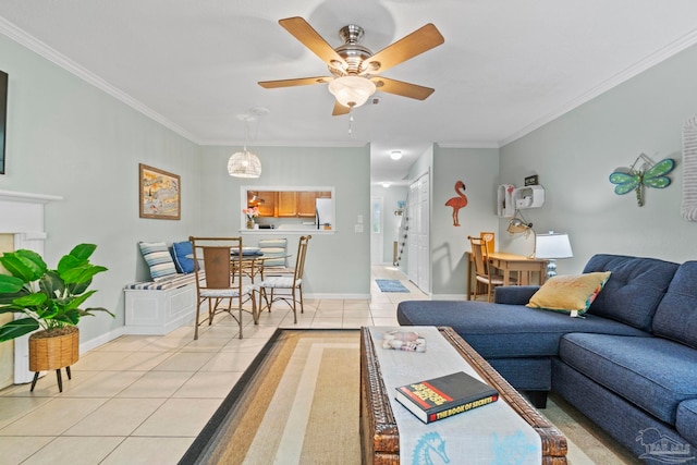 living area with baseboards, ornamental molding, a ceiling fan, and light tile patterned floors