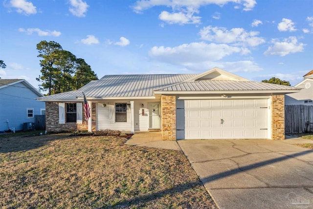 ranch-style home featuring metal roof, an attached garage, brick siding, fence, and driveway