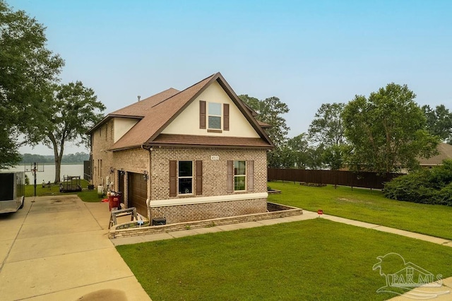 4513 River Ranch Rd, Milton, FL 32583 - view of front facade with brick siding, driveway, stucco siding, and an attached garage