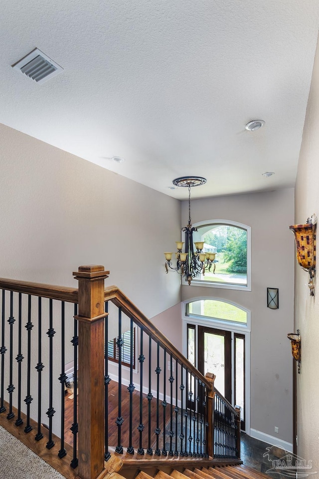 4513 River Ranch Rd, Milton, FL 32583 - entryway with a chandelier, wood finished floors, a textured ceiling, and stairway