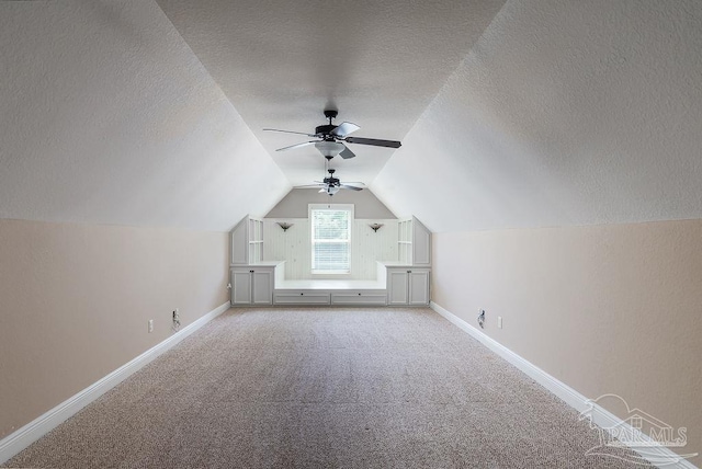 4513 River Ranch Rd, Milton, FL 32583 - additional living space featuring a textured ceiling, carpet floors, vaulted ceiling, and ceiling fan