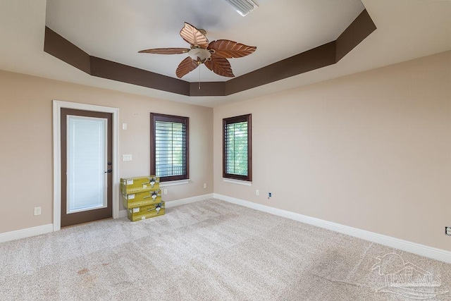4513 River Ranch Rd, Milton, FL 32583 - carpeted empty room with a tray ceiling and ceiling fan