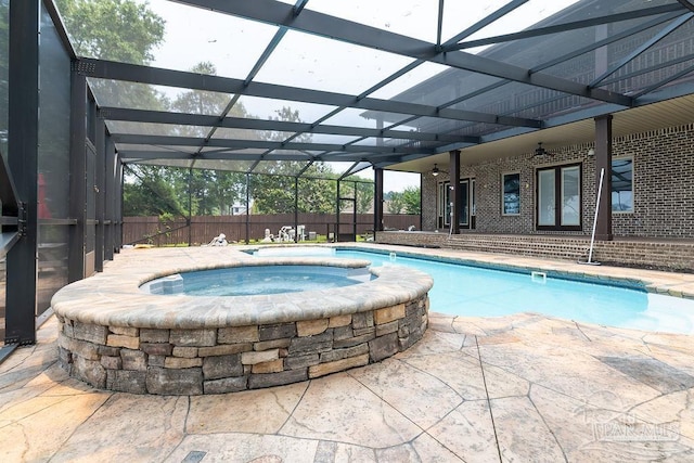 4513 River Ranch Rd, Milton, FL 32583 - view of swimming pool featuring an in-ground hot tub, glass enclosure, a patio, and ceiling fan
