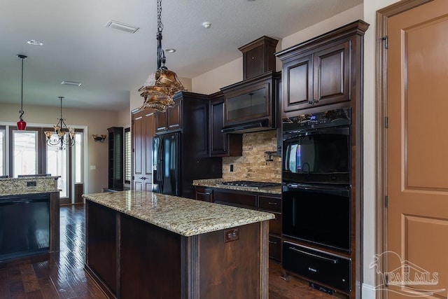 4513 River Ranch Rd, Milton, FL 32583 - kitchen with black appliances, a warming drawer, backsplash, dark wood-type flooring, and a kitchen island