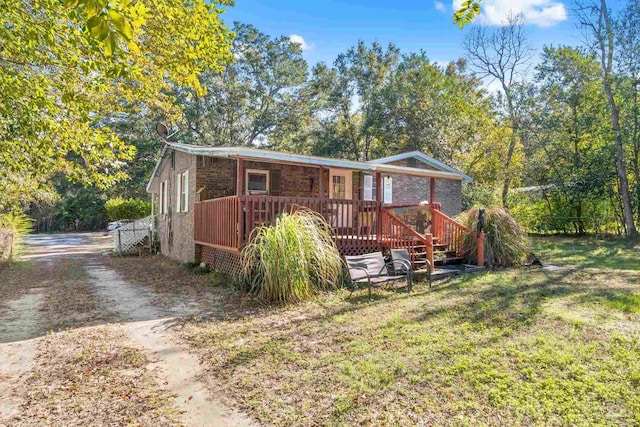 view of front of house featuring a front yard and a deck