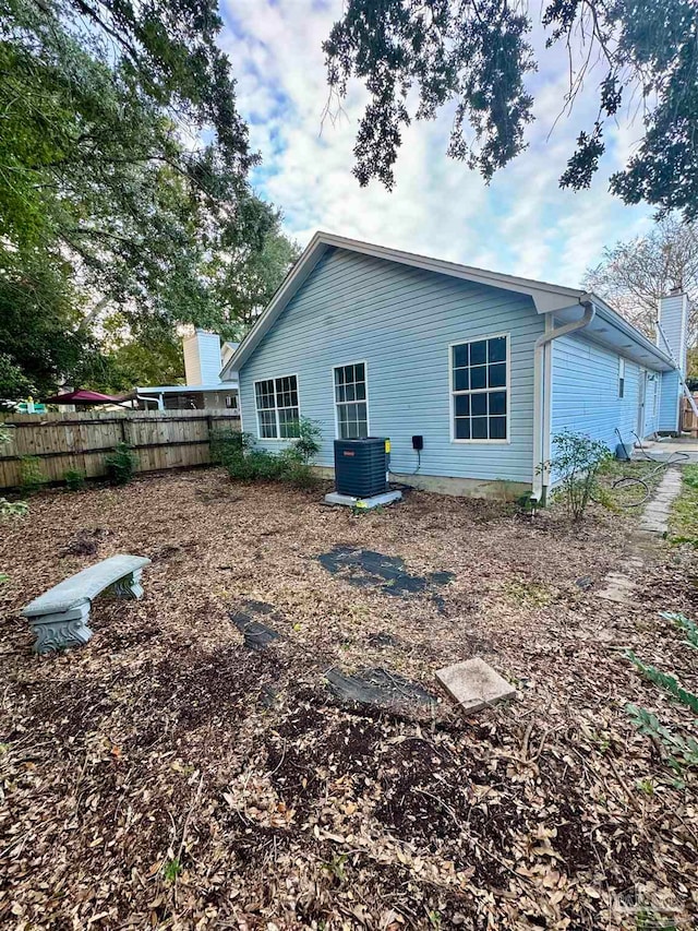 back of property featuring central AC