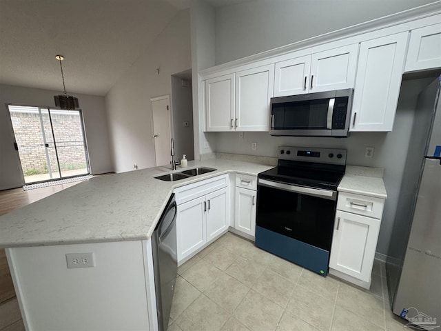 kitchen featuring kitchen peninsula, stainless steel appliances, and lofted ceiling