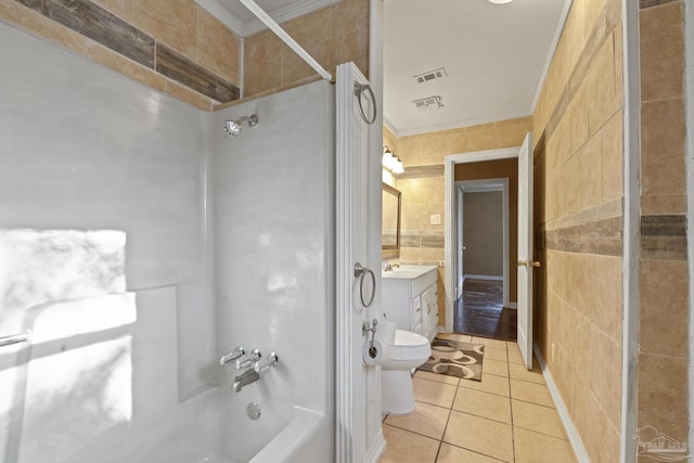 full bathroom with crown molding, tile walls, tile patterned floors, and washtub / shower combination