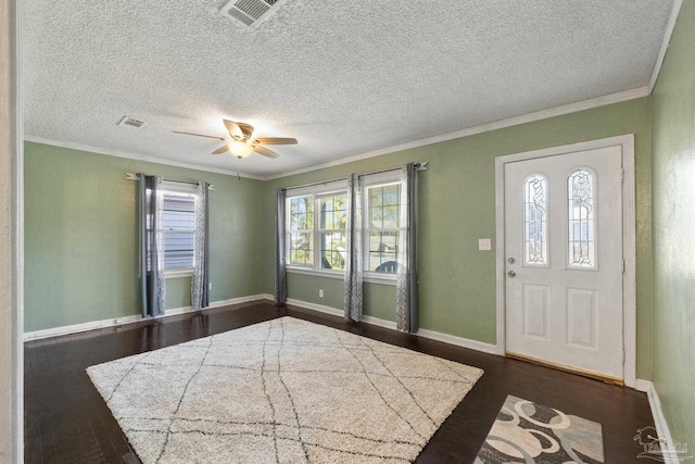 foyer featuring ceiling fan, ornamental molding, and dark hardwood / wood-style flooring