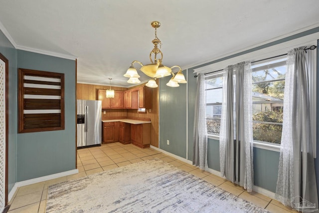 kitchen featuring decorative light fixtures, ornamental molding, light tile patterned floors, stainless steel fridge with ice dispenser, and an inviting chandelier