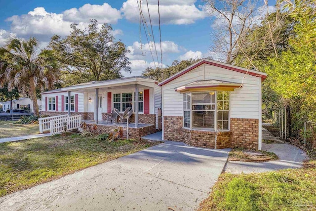 view of front of house featuring a front yard and covered porch