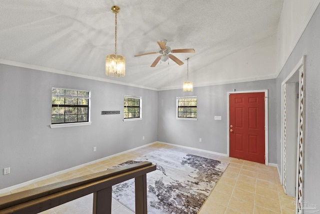 tiled entrance foyer with vaulted ceiling, ceiling fan, and a textured ceiling