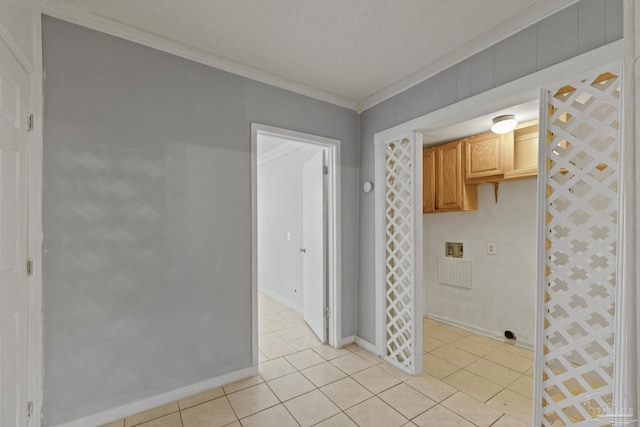 kitchen with light brown cabinets, ornamental molding, light tile patterned floors, and a textured ceiling