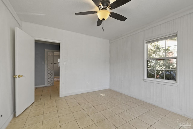 unfurnished room with light tile patterned floors and ceiling fan