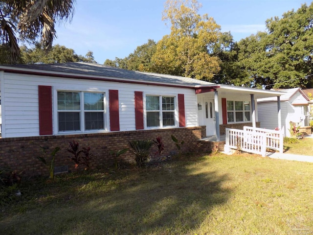 ranch-style house with a porch and a front lawn