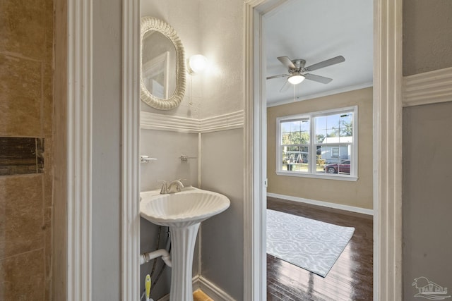 bathroom with hardwood / wood-style flooring, crown molding, and ceiling fan