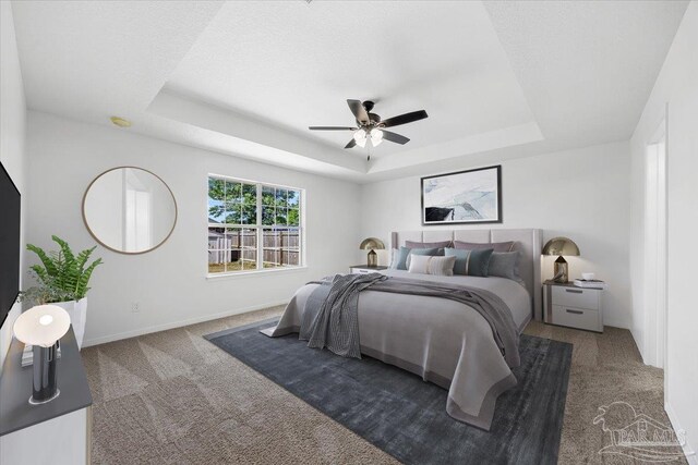6914 Raburn Rd, Pensacola, FL 32526 - carpeted bedroom featuring baseboards, a ceiling fan, and a tray ceiling