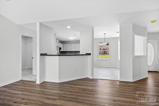 6914 Raburn Rd, Pensacola, FL 32526 - kitchen featuring baseboards, dark wood finished floors, and dark countertops