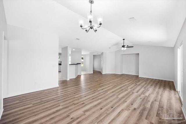 6914 Raburn Rd, Pensacola, FL 32526 - unfurnished living room with light wood finished floors, ceiling fan with notable chandelier, baseboards, vaulted ceiling, and visible vents