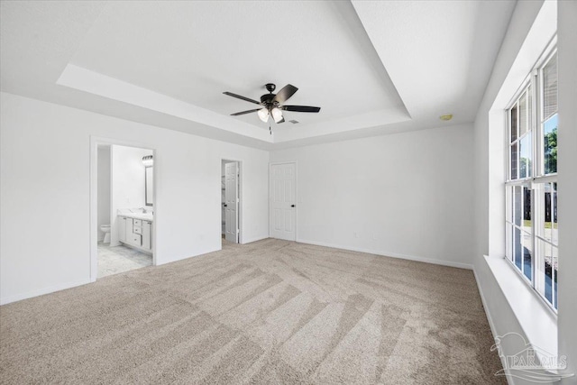 6914 Raburn Rd, Pensacola, FL 32526 - carpeted spare room featuring baseboards, a ceiling fan, and a tray ceiling