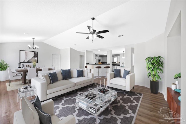 6914 Raburn Rd, Pensacola, FL 32526 - living room with visible vents, vaulted ceiling, wood finished floors, baseboards, and ceiling fan with notable chandelier