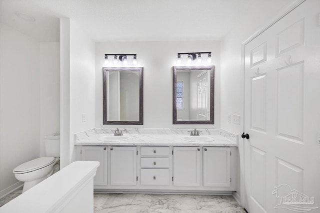6914 Raburn Rd, Pensacola, FL 32526 - bathroom featuring double vanity, toilet, a sink, and marble finish floor